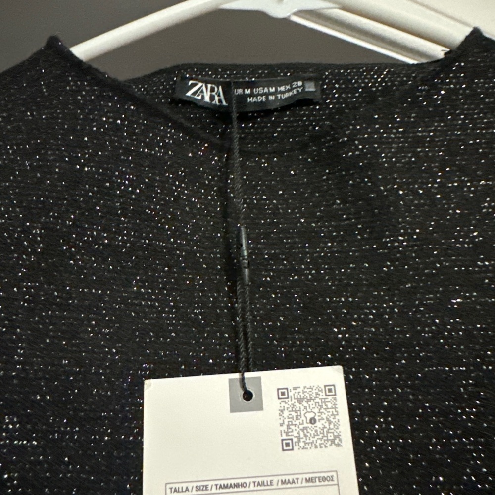 Black mini dress with silver sparkles.